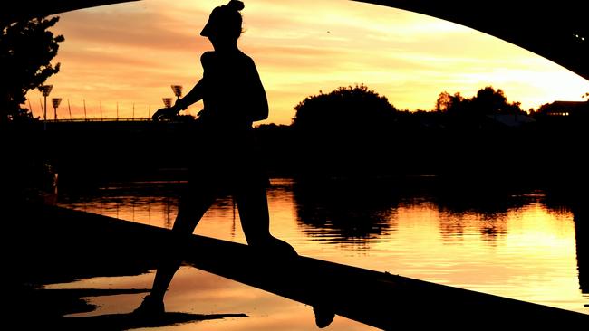 A runner jumps puddles in Melbourne. Picture: Nicole Garmston