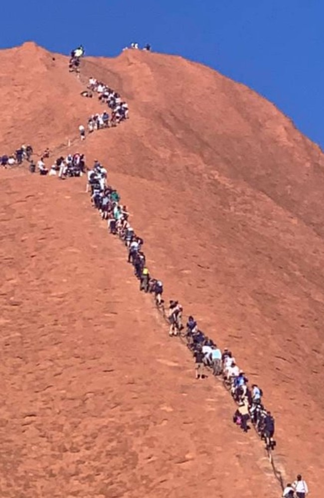 Tourists snaking up Uluru yesterday. Picture: Glenn Minett