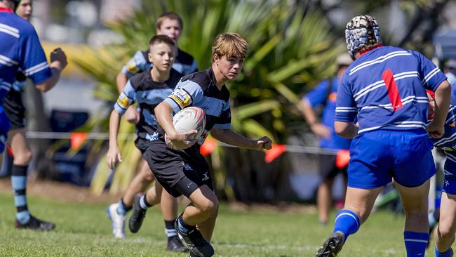 Day One of King of the Country rugby tournament at James Overell Park, Southport. Maroochydore Swans U14s' Brock Coombes in against USQ Saints U14s (blue white small stripes). Picture: Jerad Williams