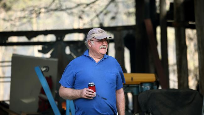 John Britten surveys his burnt-out shed and counts his blessings after firefighters saved his house at Greta. Picture: Peter Lorimer