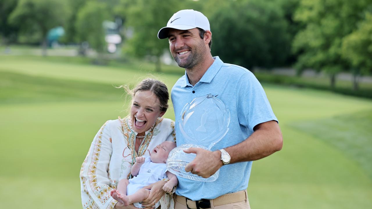 Scheffler poses with the trophy with wife Meredith and son Bennett after winning the Memorial Tournament.