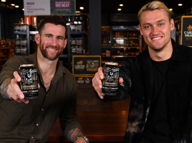 MELBOURNE, AUSTRALIA - OCTOBER 06: Jeremy Howe and Darcy Moore pose with the premiership cans during the 2023 Collingwood Magpies Premiership Cans Launch at Dan Murphy's Richmond on October 06, 2023 in Melbourne, Australia. (Photo by Josh Chadwick/Getty Images for TLA)