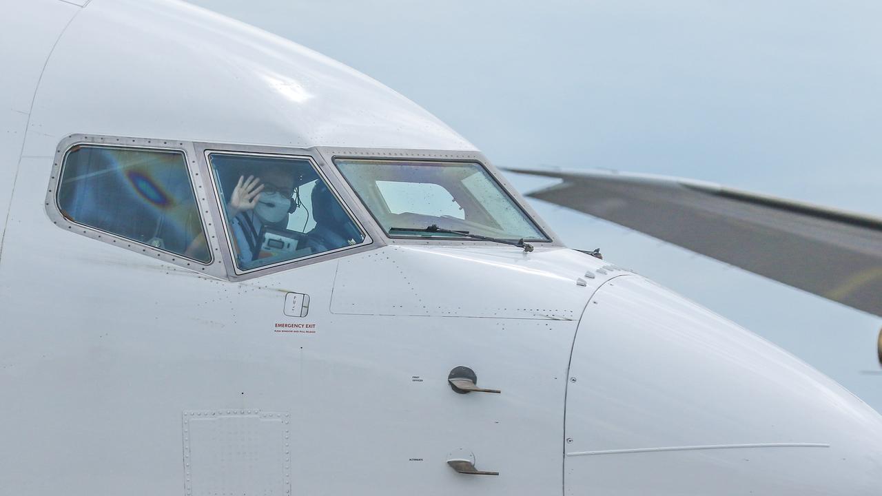 Pilots wave as the First SIngapore Airlines regular service lands in Darwin today. Picture: Glenn Campbell