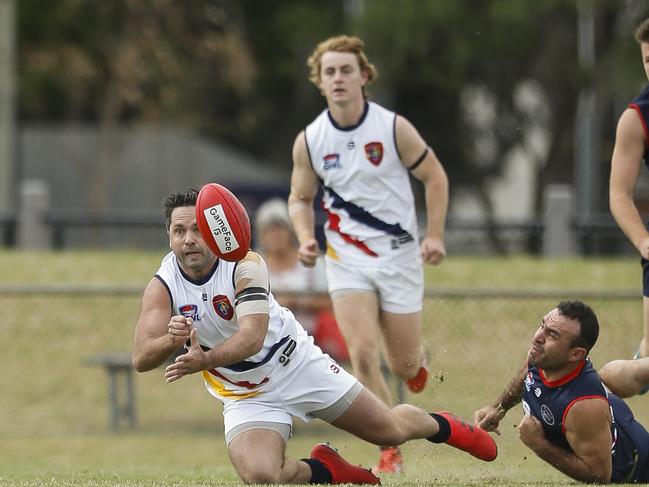 Caulfield coach Chris O'Keefe shoots out as handball. Picture: Valeriu Campan