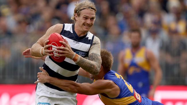 Tom Stewart is tackled by Mark LeCras.