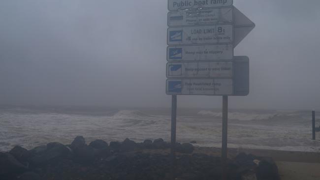 Waves crash across the rocks at the Dayman Point boat ramp just south of the Daintree River. Peter Carruthers