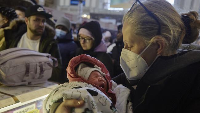 German citizen Margarete holds her baby Josephine in the train station in Kyiv, Ukraine. Picture: Getty Images