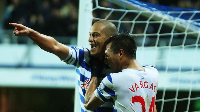 Bobby Zamora (L) and Eduardo Vargas of QPR celebrate after Martin Demichelis own goal.