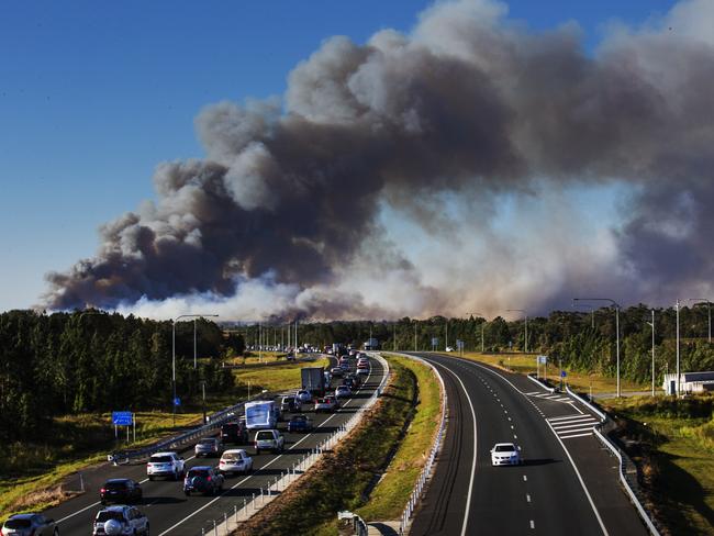 Bushfire at Caloundra West approaches the Bruce Highway as traffic comes to a standstill at Bells Creek. Photo Lachie Millard