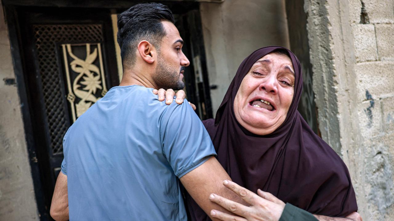 A Palestinian woman is consoled by a man as she mourns the loss of loved ones in the aftermath of an Israeli air strike in Rafah. Picture: AFP