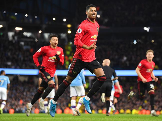 MANCHESTER, ENGLAND - DECEMBER 07: Marcus Rashford of Manchester United celebrates scoring a penalty to make it 1-0 during the Premier League match between Manchester City and Manchester United at Etihad Stadium on December 07, 2019 in Manchester, United Kingdom. (Photo by Michael Regan/Getty Images)