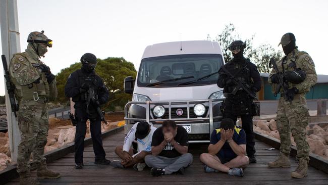 Special ops with three of the nine men who were eventually arrested.