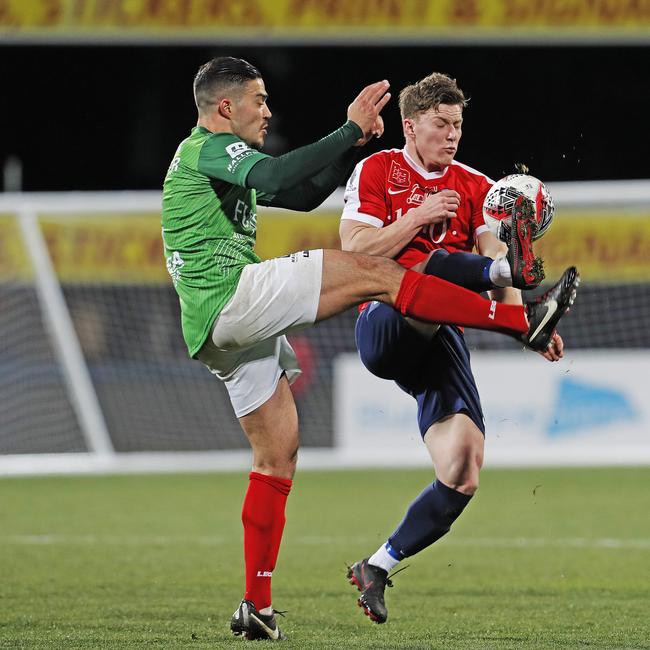 Marconi’s Roberto Speranza and South Hobart's Darcy Hall compete for the ball. Picture: ZAK SIMMONDS