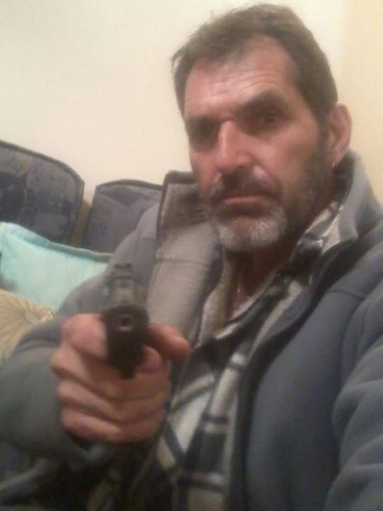 Heinze posed with a handgun in this image from one of his online profiles.