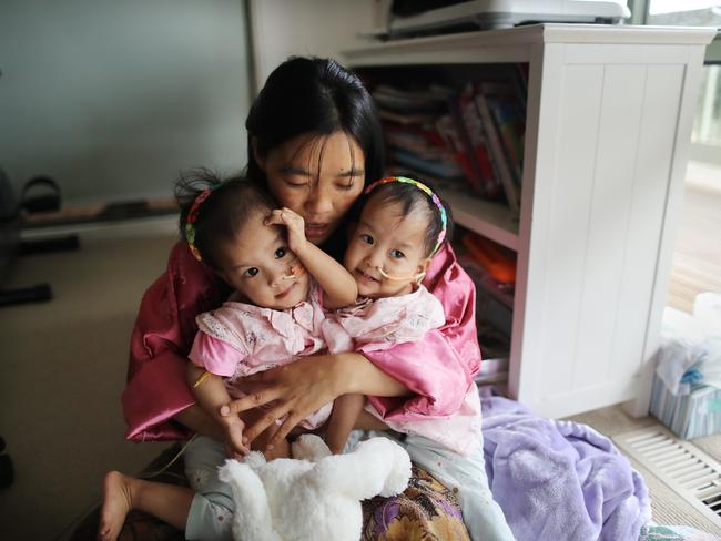 Nima (right) and Dawa (left) will share a goodbye cuddle with mum Bhumchu just after 8am before being taken into surgery at the Royal Children's Hospital. Picture: Alex Coppel