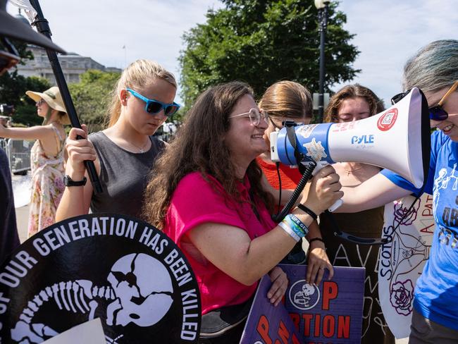 WASHINGTON, DC - JUNE 26: Anti-abortion demonstrators pray in front of the Supreme Court on June 26, 2024 in Washington, DC. A ruling is expected this week in the case of Moyle v. United States, which will determine if hospitals in states with abortion bans will be required by law to provide abortion procedures in emergency situations.   Anna Rose Layden/Getty Images/AFP (Photo by Anna Rose Layden / GETTY IMAGES NORTH AMERICA / Getty Images via AFP)