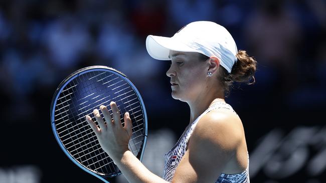 Ashleigh Barty of Australia straightens the strings