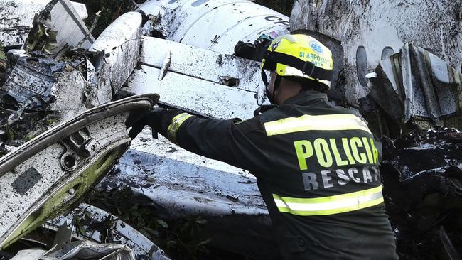 A rescue policeman works at the site of the plane crash near Medellin, Colombia. Picture: AP