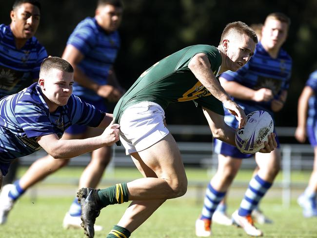 L to R: Patrician Brothers' Bailey Myers tackles Farrers'  Farrer's Jordan Hamlin. Season Opener for the Peter Mulholland Schoolboys Cup  between Farrer Memorial Agricultural High School  Casula (in green) and Patrician Brothers Fairfield (in blue) at New Era Stadium, Cabramatta.  Picture: John Appleyard