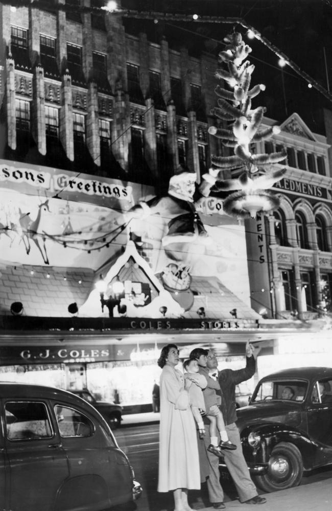 The Mitchell family, of Carnegie, look up at the Christmas decorations in Bourke St in 1955.