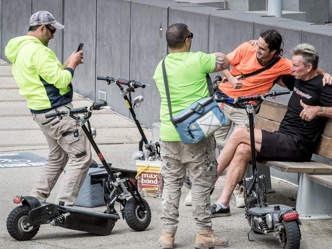 Sam Newman, who is seriously considering a run for lord mayor, poses for photos with fans outside his Docklands apartment. Picture: Jake Nowakowski