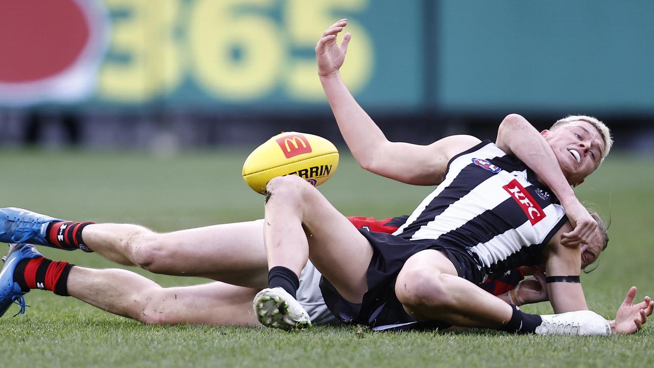 Essendon’s Mason Redman tackles Jack Ginnivan at the Melbourne Cricket Ground. Picture: Darrian Traynor