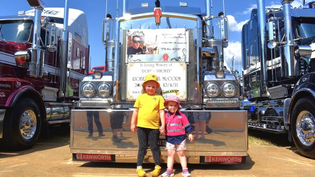 Matilda Pollard and Charlotte Smith stand in front of their grandfather's memorial on their uncle Tex's tuck at the Lights On The Hill 2023 event.