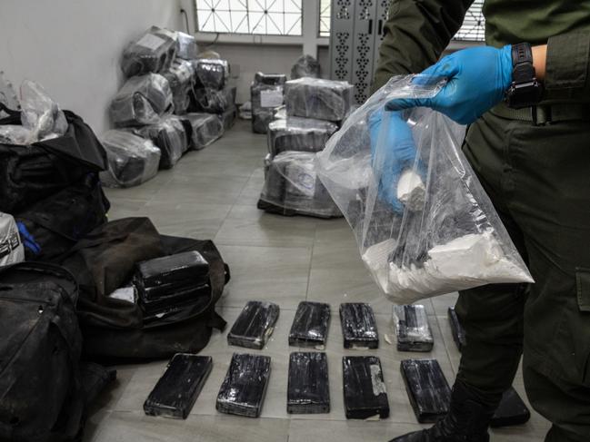 Patrol officer Jorge Vega with 800kg of cocaine - worth $300,000 per kilo - at a secure location in Cartagena, Colombia. Picture: Jason Edwards