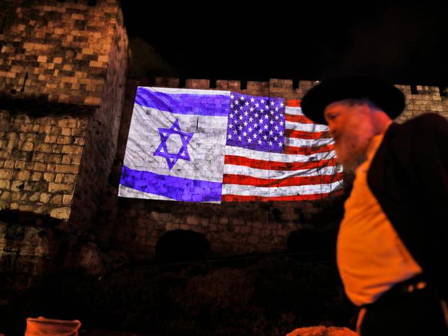 A giant US flag screened alongside Israel's national flag by the Jerusalem municipality on the walls of the old city. Picture: AFP/Ahmad Gharabli