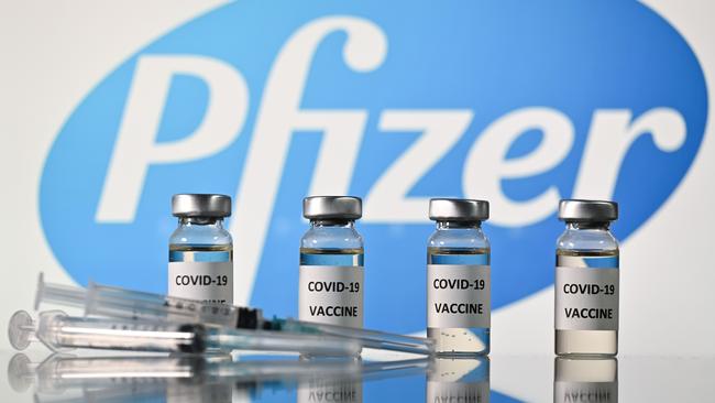 Vials with COVID-19 vaccine stickers attached and syringes with the logo of US pharmaceutical company Pfizer. Picture: AFP