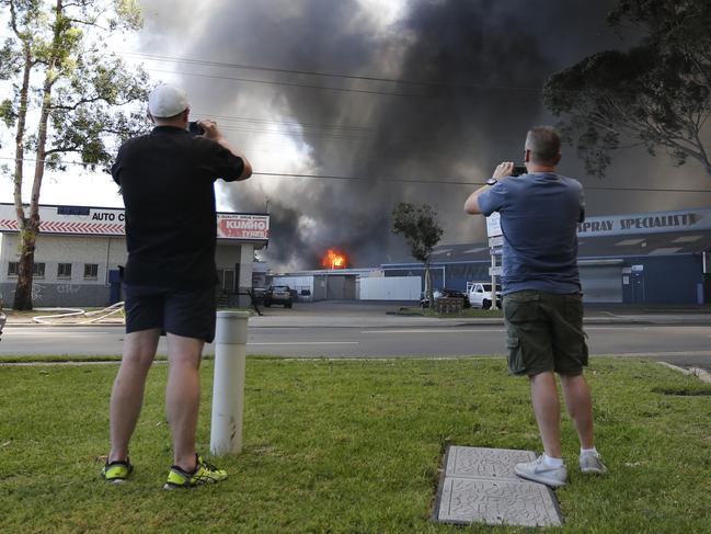 Locals capturing the fire on their mobile phones. Picture: Richard Dobson