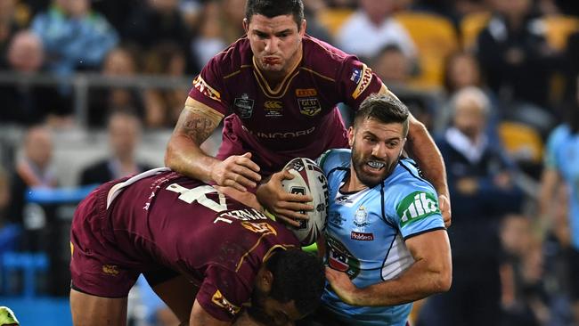 James Tedesco of the NSW Blues (right) is tackled during Game one of the State of Origin series.