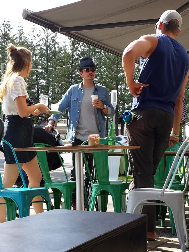 Orlando Bloom enjoying coffee at Elk Espresso this morning with a nanny and minder, with son Flynn in a stroller by his side.