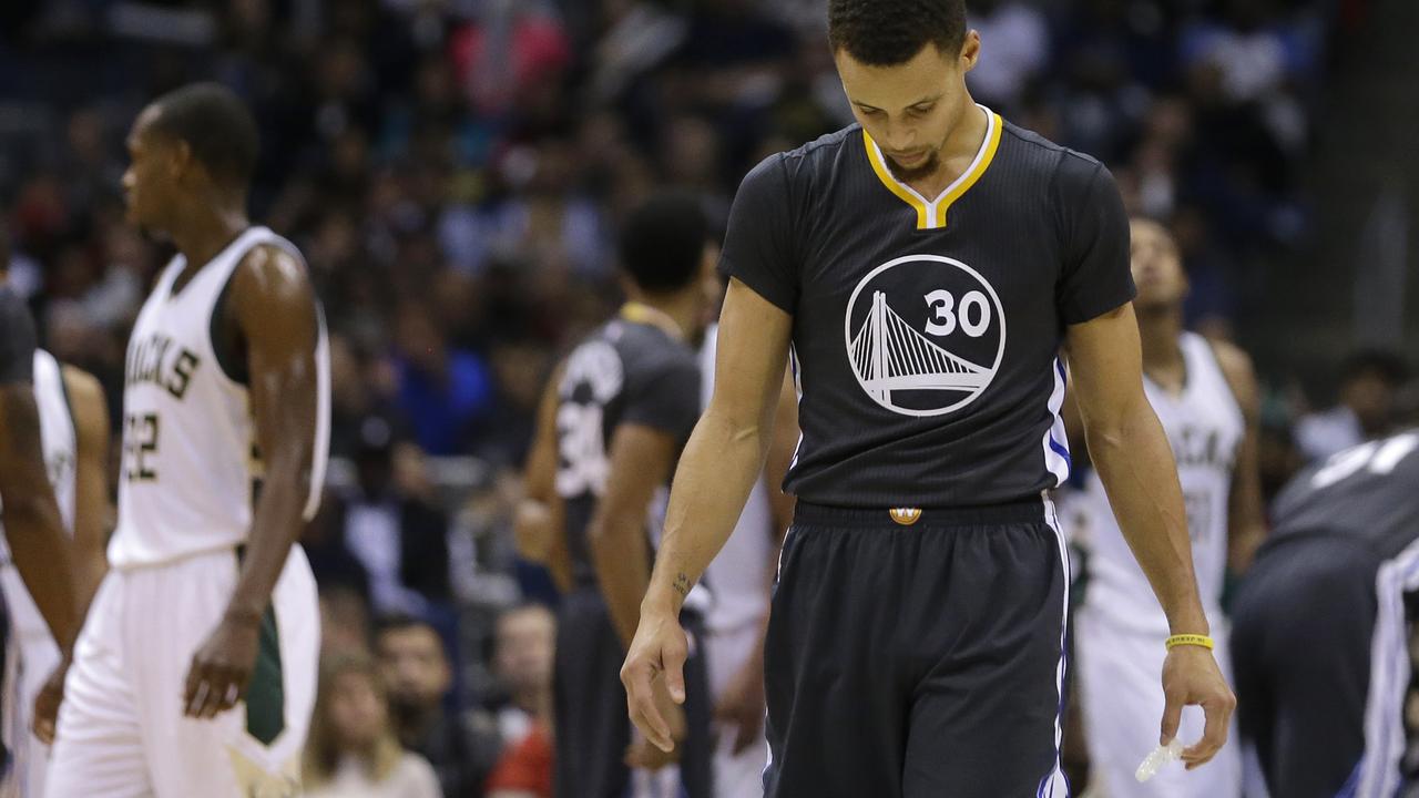 Golden State Warriors' Stephen Curry looks down during the second half of an NBA basketball game against the Milwaukee Bucks Saturday, Dec. 12, 2015, in Milwaukee. The Bucks won 108-95. (AP Photo/Aaron Gash)