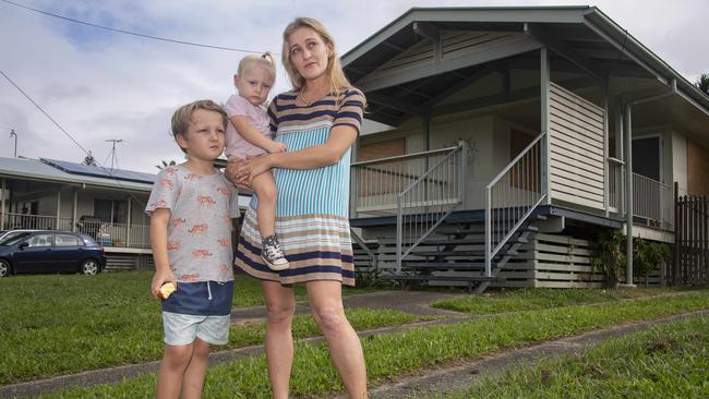 Holly Vincent and her children Levi (9) and Amolika (2) want to move into the boarded up three bedroom house at house at 17 Enmore Street. Picture: Brian Cassey