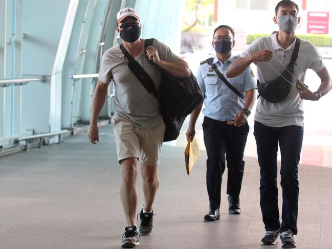 "David Van Iersel is escorted by an immigration officer. Picture: Lukman S. Bintoro