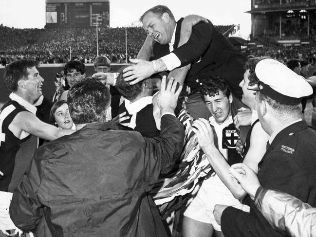 St Kilda coach Allan Jeans celebrates with the players after the 1966 Grand Final. Brian Sierakowski leans forward to embrace captain Darrel Baldock.