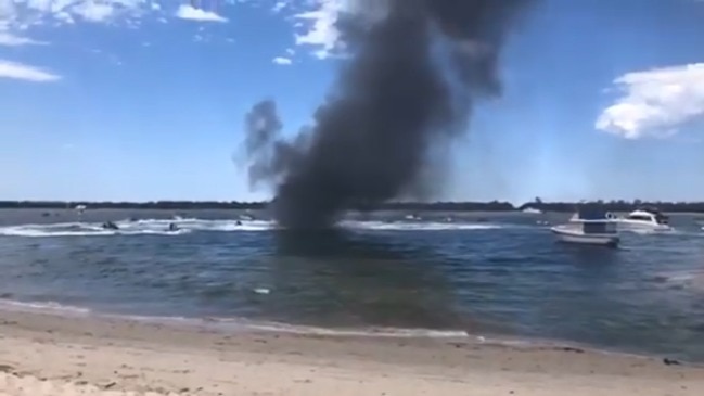 Jetski riders help to put out a houseboat fire