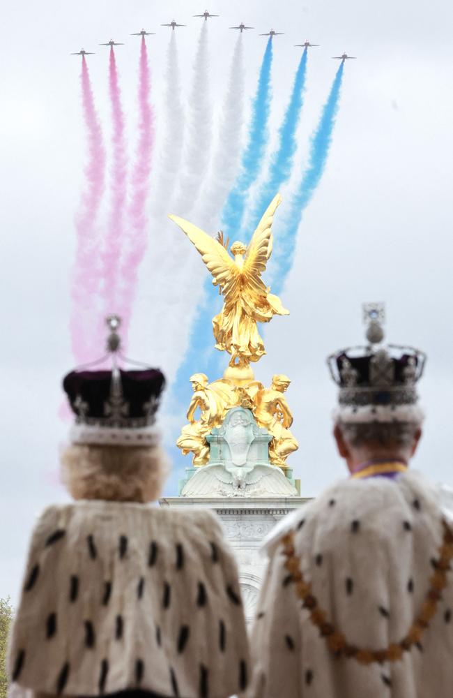 Queen Camilla and King Charles III standing on the balcony of Buckingham Palace to view the Royal Air Force's Red Arrows fly-past. Picture: Getty