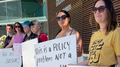 Supporters of the homeless at Carey Park stage a protest outside the Gold Coast City Council chambers about the City's tough compliance policy. Jenna Schroeder is pictured far right.