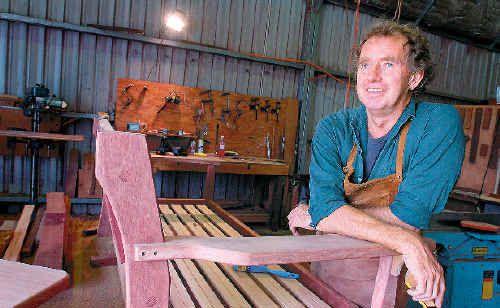 Good wood: Adrian Williamson leaves minimal carbon footprint in the production of Nimbin Garden Furniture. His tools are powered by solar panels on the roof and he uses recycled timber. Picture: Cathy Adams