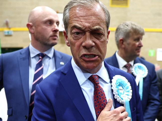 TOPSHOT - Reform UK leader Nigel Farage reacts after being elected to become MP for Clacton at the Clacton count centre in Clacton-on-Sea, eastern England, early on July 5, 2024. Britain's main opposition Labour party looks set for a landslide election win, exit polls indicated, with Keir Starmer replacing Rishi Sunak as prime minister, ending 14 years of Conservative rule. Sunak's Tories would only get 131 -- a record low -- with the right-wing vote apparently spliced by Nigel Farage's anti-immigration Reform UK party, which could bag 13 seats. (Photo by HENRY NICHOLLS / AFP)