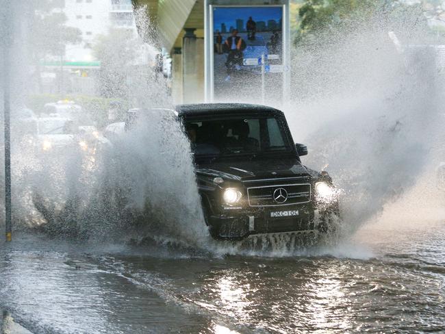 Cars drive through floods at New South Head Road, Rushcutters bay,  during a heavy downpour of rain. pic Mark Evans