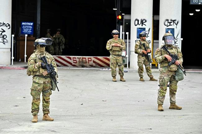 Members of the National Guard stand guard in front of a federal building in downtown Los Angeles, California on June 8, 2025