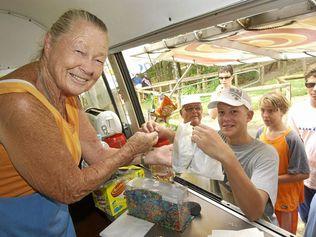 Betty Wallace serves Campbell Marr at Betty's Beach Burgers, Noosa in 2003. Picture: Warren Lynam