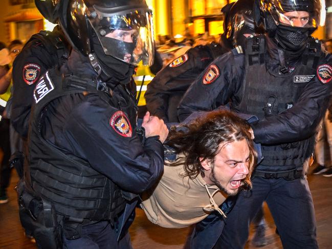 Police officers detain a man following in Moscow. Picture: AFP