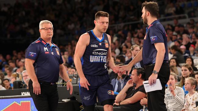 Matthew Dellavedova leaves the court following a collision. (Photo by Kelly Defina/Getty Images)