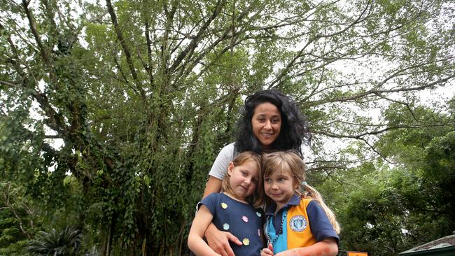 Nell Venables and her daughters Neve Ireland 5 and Willow Walker 6 in front of the big fig tree on Collins Ave St Edge Hill that is infected with fungus and may have to be removed. PICTURE: ANNA ROGERS