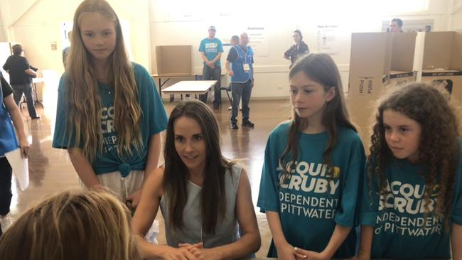 Teal independent Jacqui Scruby voting on Saturday, watched by her three daughters, in Pittwater.