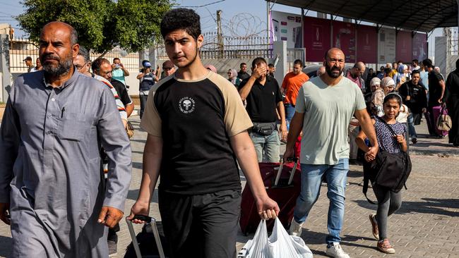 People walk through a gate to enter the Rafah border crossing to Egypt in the southern Gaza Strip on Wednesday. Picture: AFP